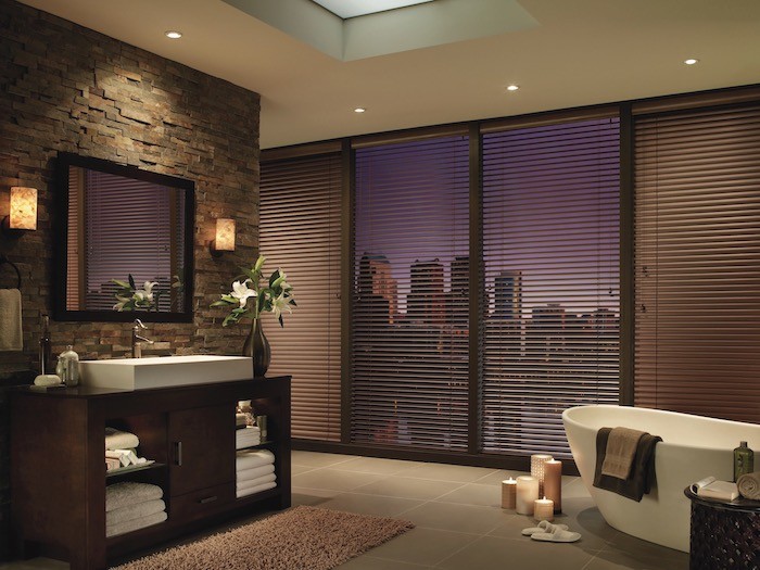 A bathroom with bathtub and lit candles.